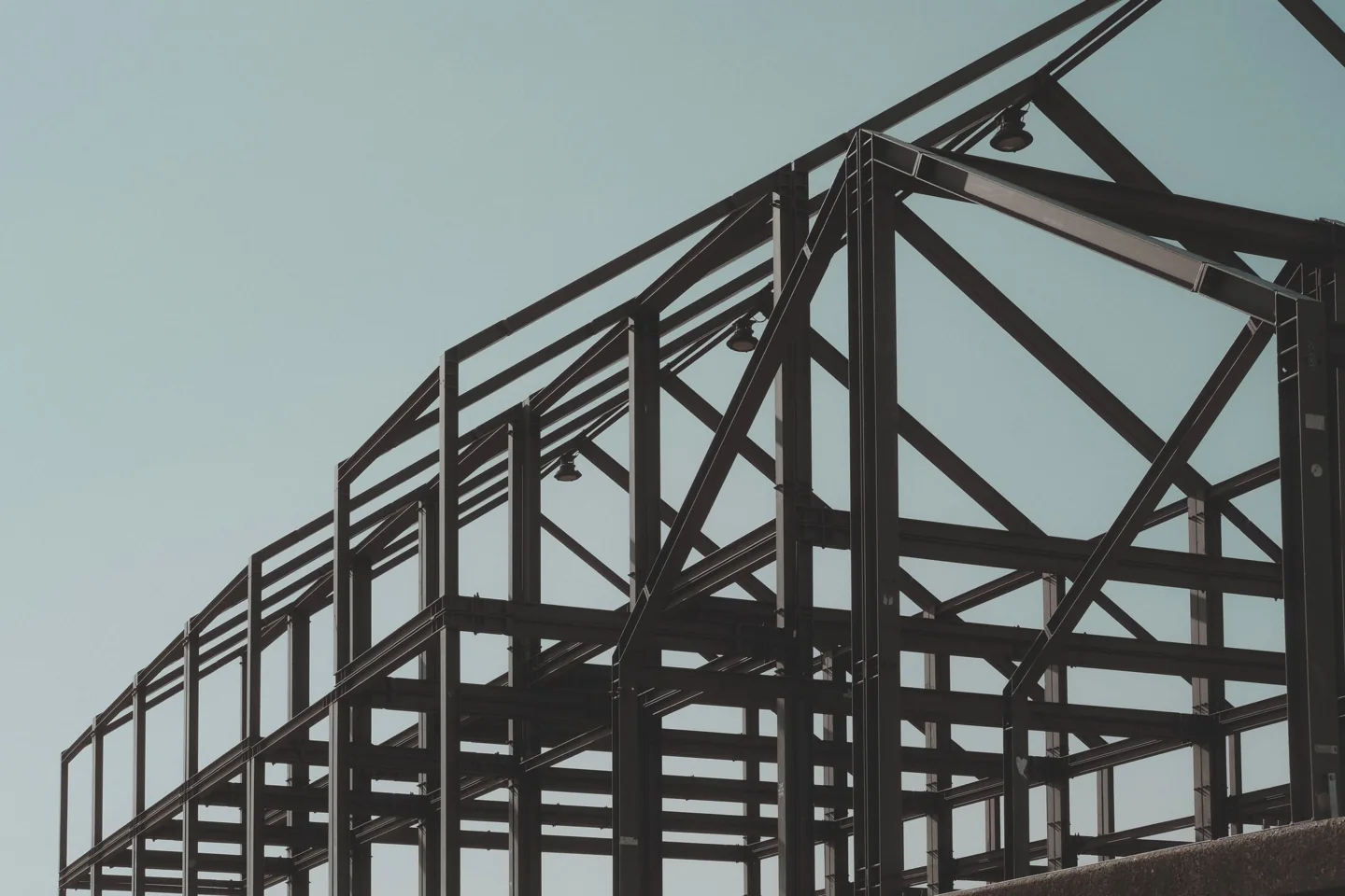 A structural steel building frame against an open sky.